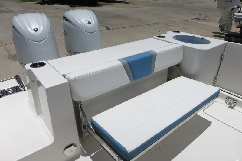 Slide: The Image of 2026 Robalo R250 Center Console boat interior with seating and dual outboard motors. - 15