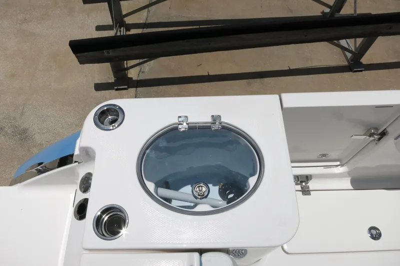 Slide: The Image of 2026 Robalo R250 Center Console boat with livewell and storage compartments. - 13