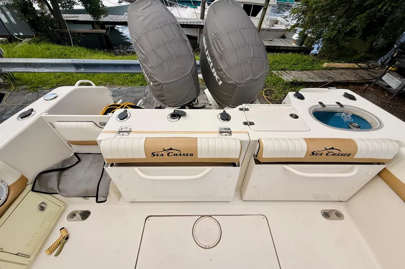 Slide: The Image of 2018 Sea Chaser 27 HFC CC boat deck with dual Suzuki engines and fishing amenities. - 19