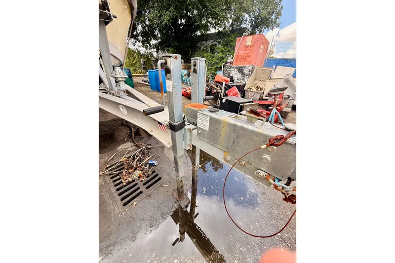 Slide: The Image of Trailer hitch of 2018 Sea Chaser 27 HFC CC boat, surrounded by tools and equipment. - 5