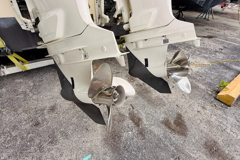 Slide: The Image of Twin outboard motors on a 2018 Sea Chaser 27 HFC CC boat, featuring stainless steel propellers. - 12