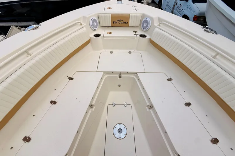 Slide: The Image of 2018 Sea Chaser 27 HFC CC boat interior with white seating and storage compartments. - 35