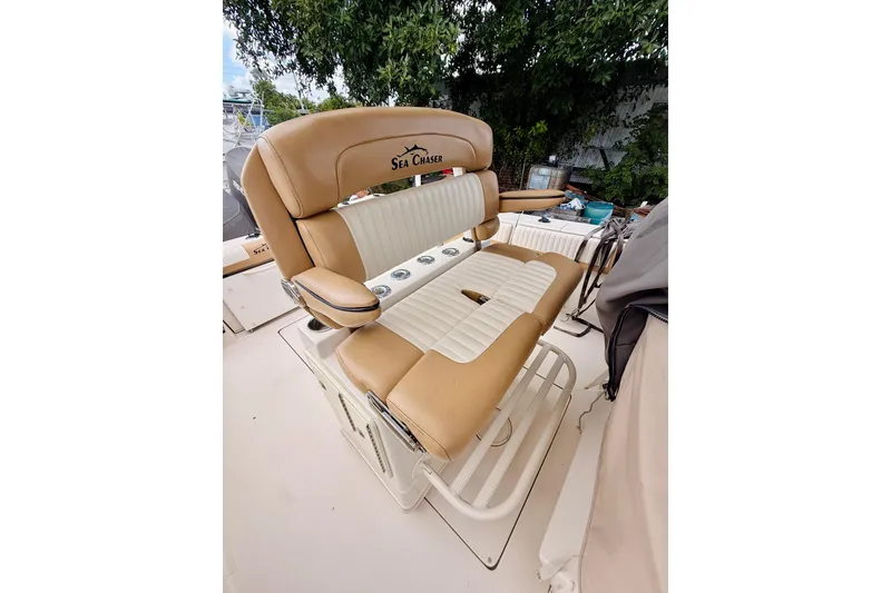 Slide: The Image of 2018 Sea Chaser 27 HFC CC boat seating with tan and white upholstery. - 26