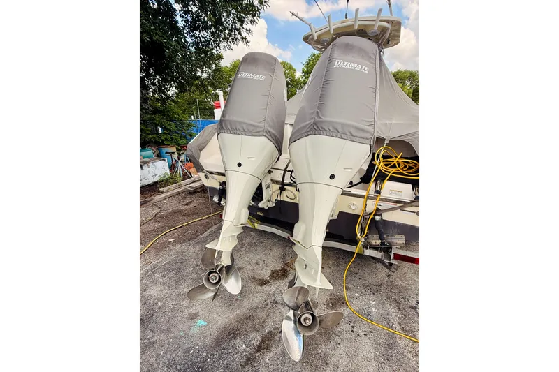Slide: The Image of Twin outboard motors on a 2018 Sea Chaser 27 HFC CC boat, covered and parked. - 11