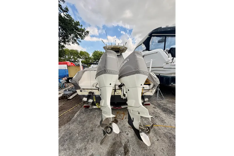 Slide: The Image of 2018 Sea Chaser 27 HFC CC boat with dual Suzuki outboard motors, parked outdoors. - 10