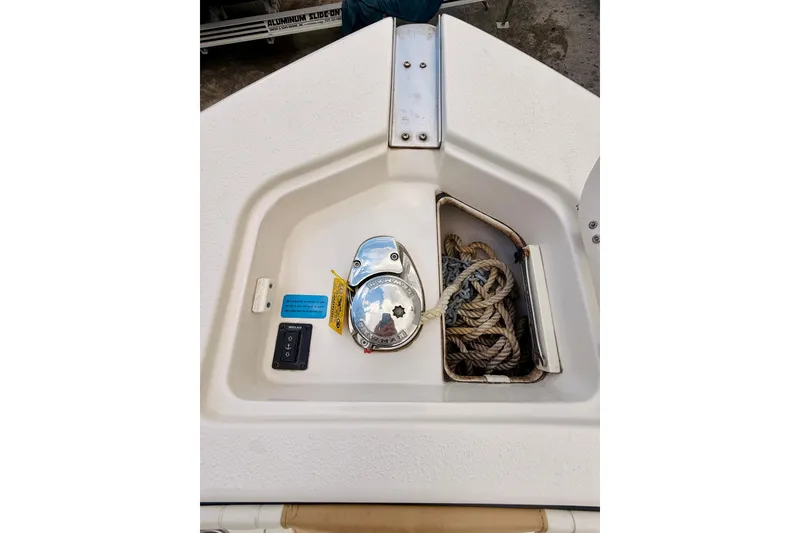Slide: The Image of 2018 Sea Chaser 27 HFC CC boat anchor compartment with ropes and controls. - 38