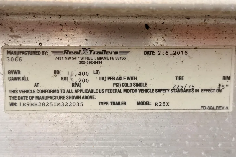 Slide: The Image of Label on Real X Trailers R28X, manufactured in 2018, showing specifications and compliance details. - 6
