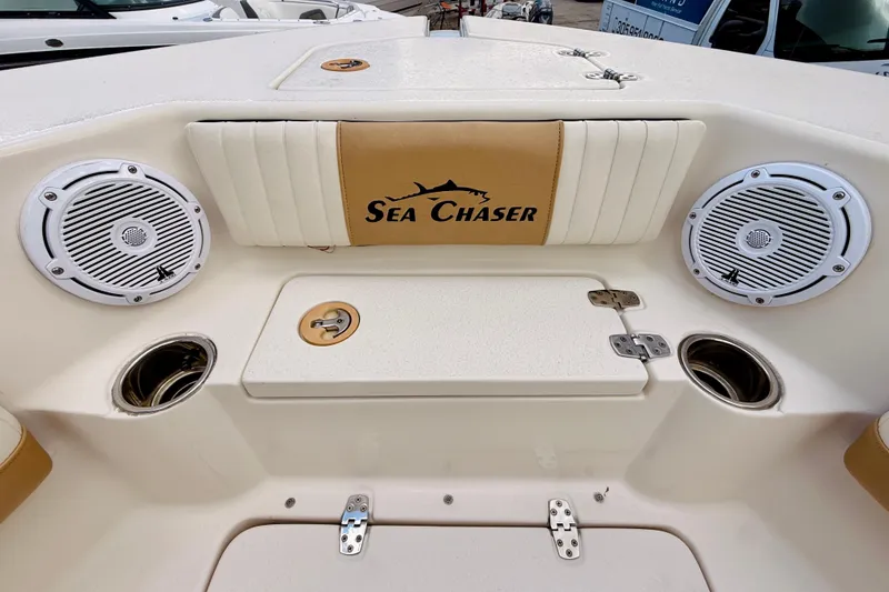 Slide: The Image of 2018 Sea Chaser 27 HFC CC boat interior with speakers and storage compartment. - 37