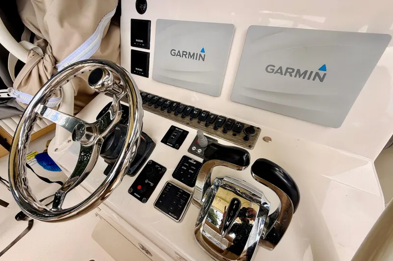 Slide: The Image of 2018 Sea Chaser 27 HFC CC helm with Garmin displays and chrome steering wheel. - 28