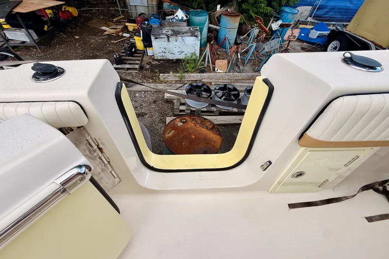 Slide: The Image of 2018 Sea Chaser 27 HFC CC boat interior with open transom door, showing storage area. - 25