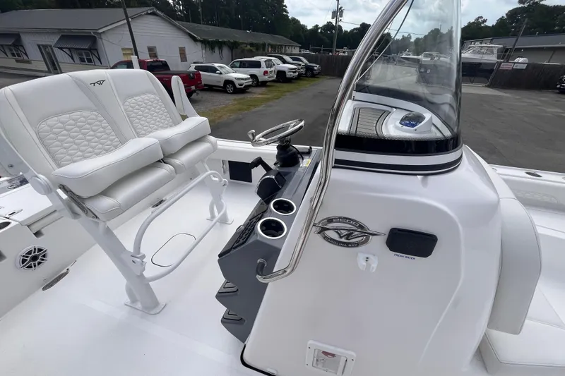 Slide: The Image of 2027 Tidewater 2500 Carolina Bay boat interior with steering console and cushioned seating. - 10