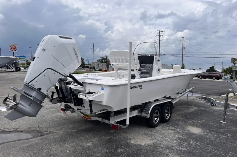Slide: The Image of 2027 Tidewater 2500 Carolina Bay boat on trailer, featuring a powerful Mercury outboard motor. - 4