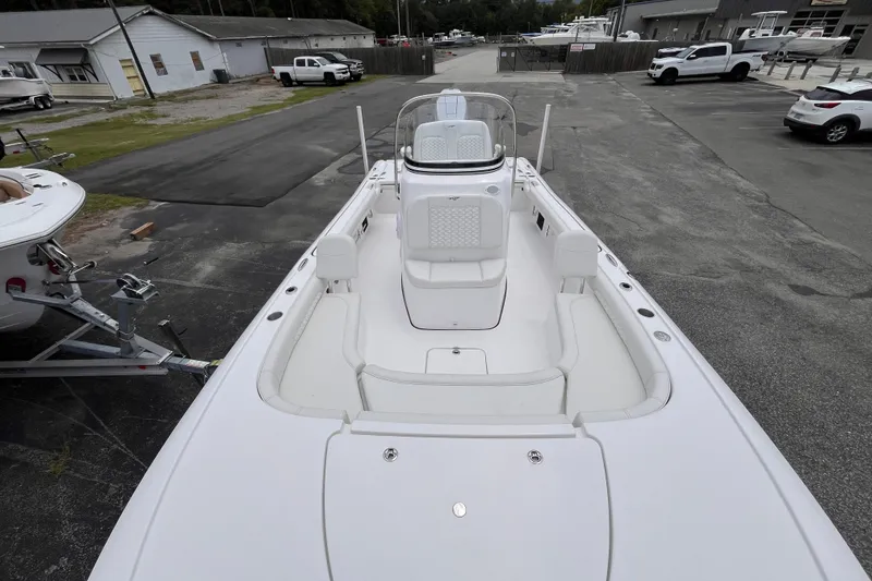 Slide: The Image of 2027 Tidewater 2500 Carolina Bay boat, white interior, parked in a marina lot. - 10