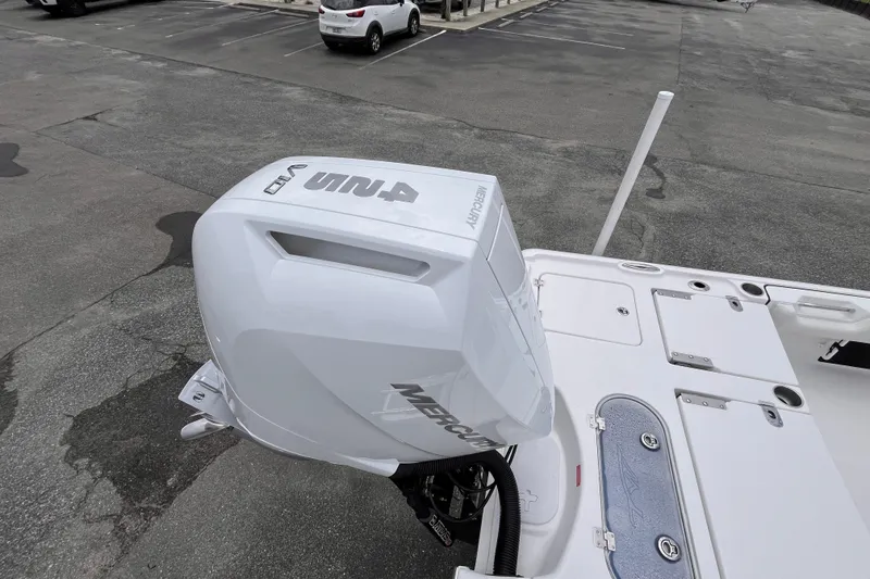 Slide: The Image of 2027 Tidewater 2500 Carolina Bay boat with Mercury outboard engine in a parking lot. - 6