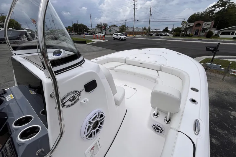 Slide: The Image of 2027 Tidewater 2500 Carolina Bay boat with white seating and modern dashboard. - 9