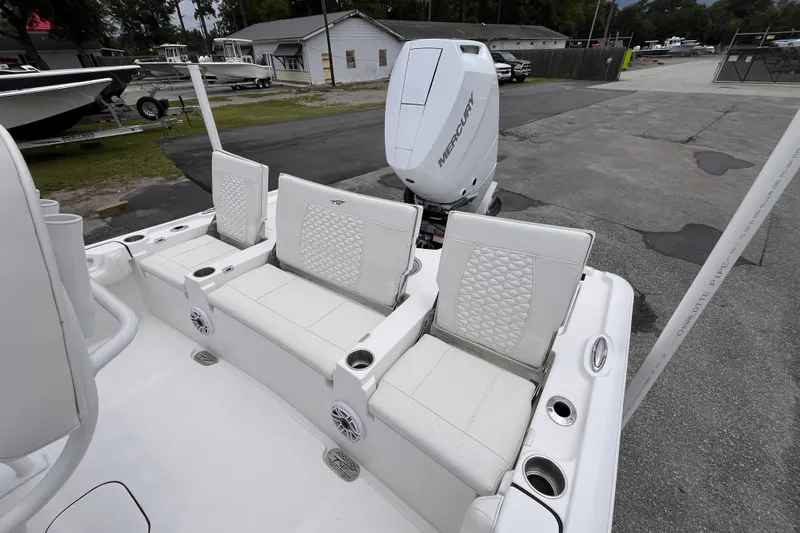Slide: The Image of 2027 Tidewater 2500 Carolina Bay boat with white seating and Mercury engine. - 14