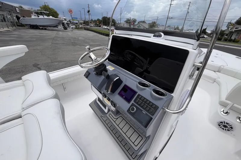 Slide: The Image of 2027 Tidewater 2500 Carolina Bay boat console with steering wheel and controls. - 8