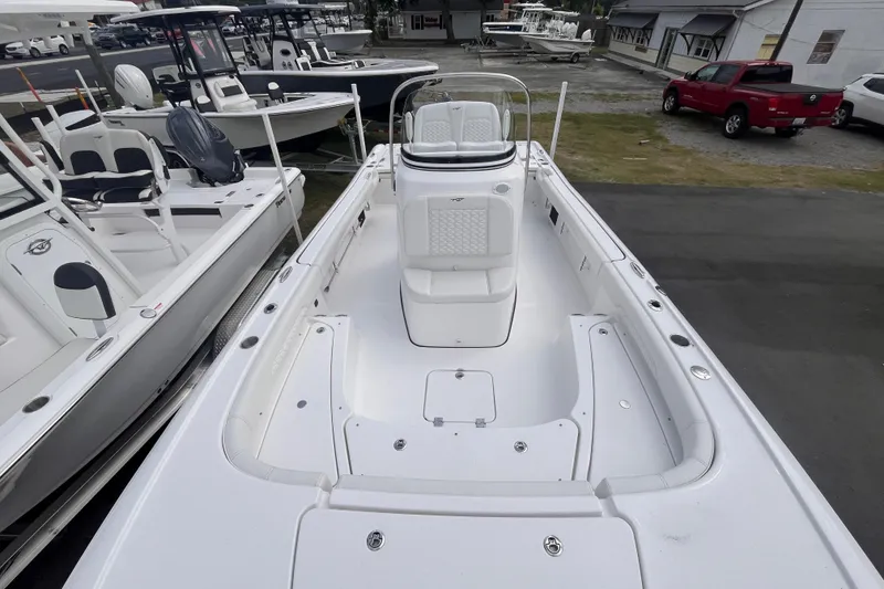 Slide: The Image of 2027 Tidewater 2500 Carolina Bay boat, white interior, docked among other boats. - 8