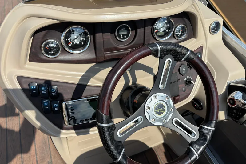 Slide: The Image of Steering console of a 2006 South Bay 23 boat with gauges and controls. - 18