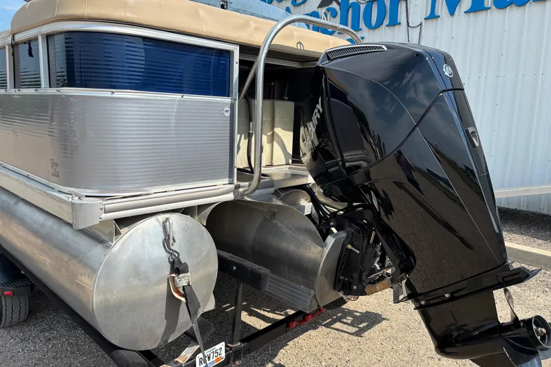 Slide: The Image of 2006 South Bay 23 pontoon boat with Mercury outboard motor, parked on trailer. - 4