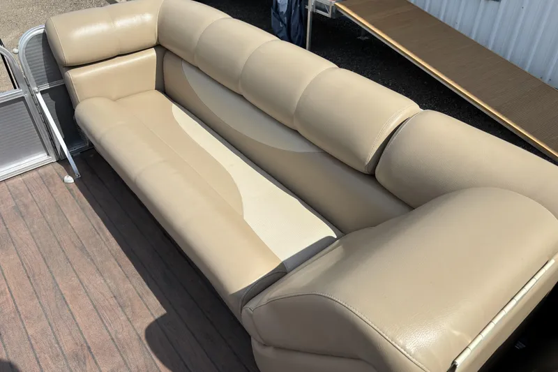 Slide: The Image of Beige seating on 2006 South Bay 23 pontoon boat, wooden deck visible. - 15