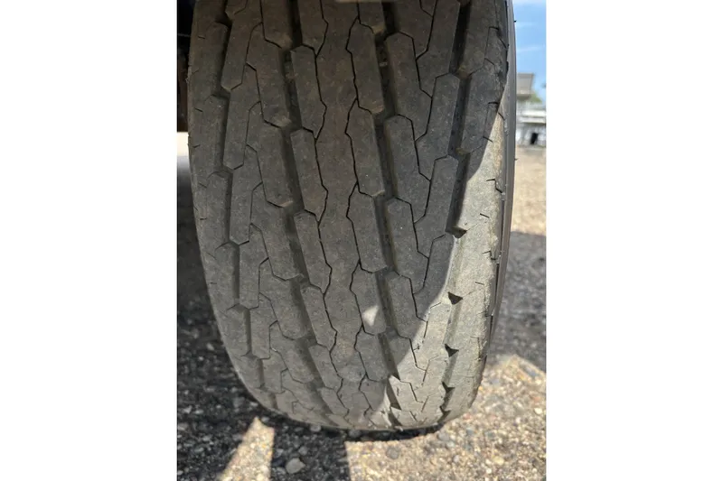 Slide: The Image of Worn tire tread on a 2006 South Bay 23 vehicle, showing significant wear. - 10