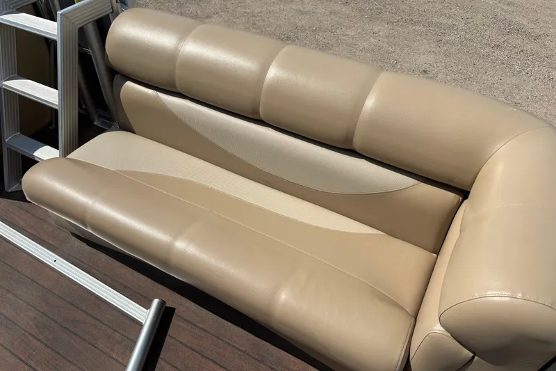 Slide: The Image of Beige leather seating on a 2006 South Bay 23 boat, with metal ladder nearby. - 16