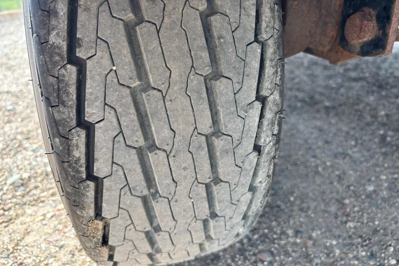Slide: The Image of Close-up of a worn tire tread on a 2006 South Bay 23 vehicle. - 11