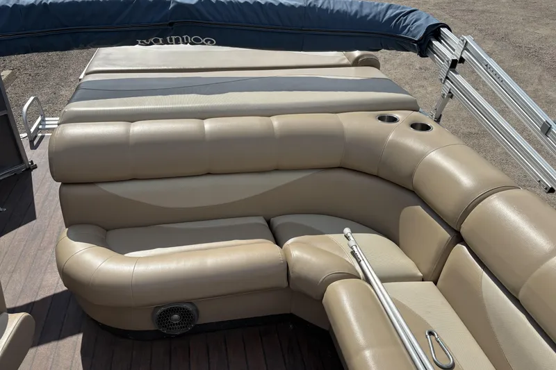 Slide: The Image of Luxurious seating on a 2006 South Bay 23 pontoon boat with beige upholstery and cup holders. - 14