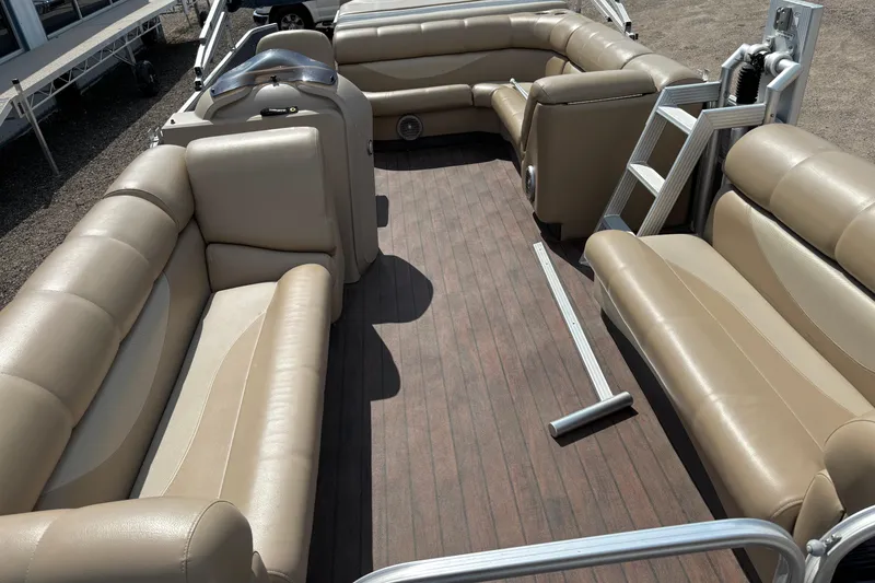 Slide: The Image of Spacious interior of a 2006 South Bay 23 pontoon boat with beige seating and wood flooring. - 13