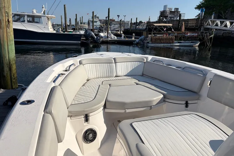 Slide: The Image of 2022 Sea Fox 268 Commander boat with spacious seating at a marina dock. - 13
