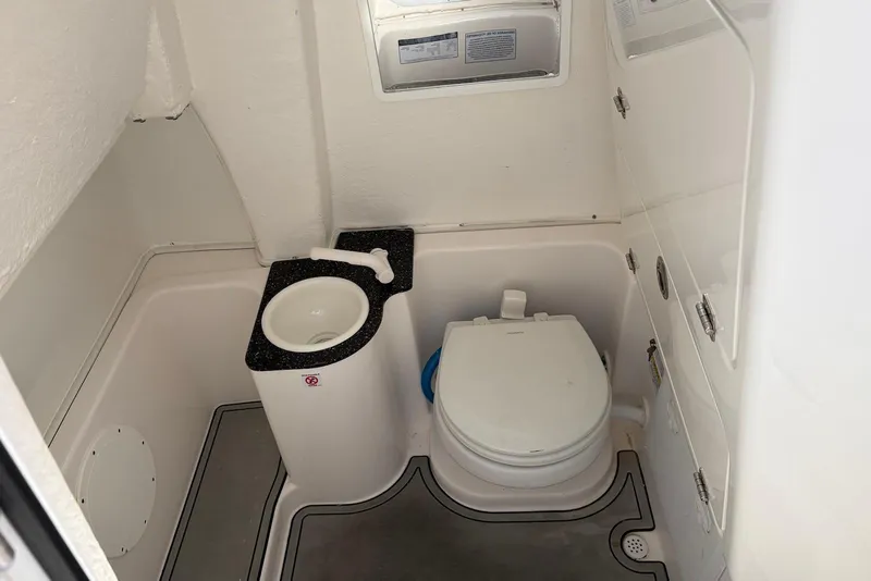Slide: The Image of 2022 Sea Fox 268 Commander boat bathroom with toilet and sink. - 17