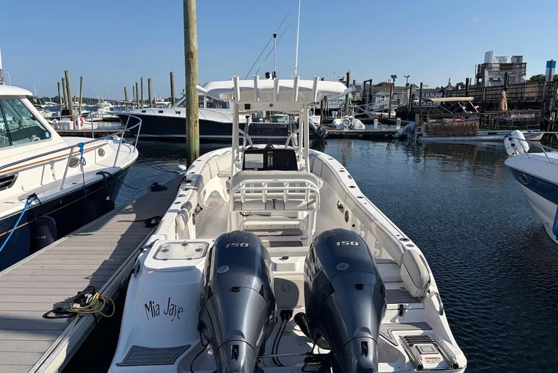 Slide: The Image of 2022 Sea Fox 268 Commander boat docked at marina with twin 150 engines. - 2