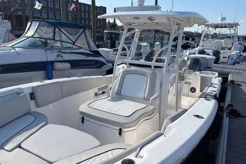 Slide: The Image of 2022 Sea Fox 268 Commander boat docked at marina, showcasing spacious seating and helm. - 9