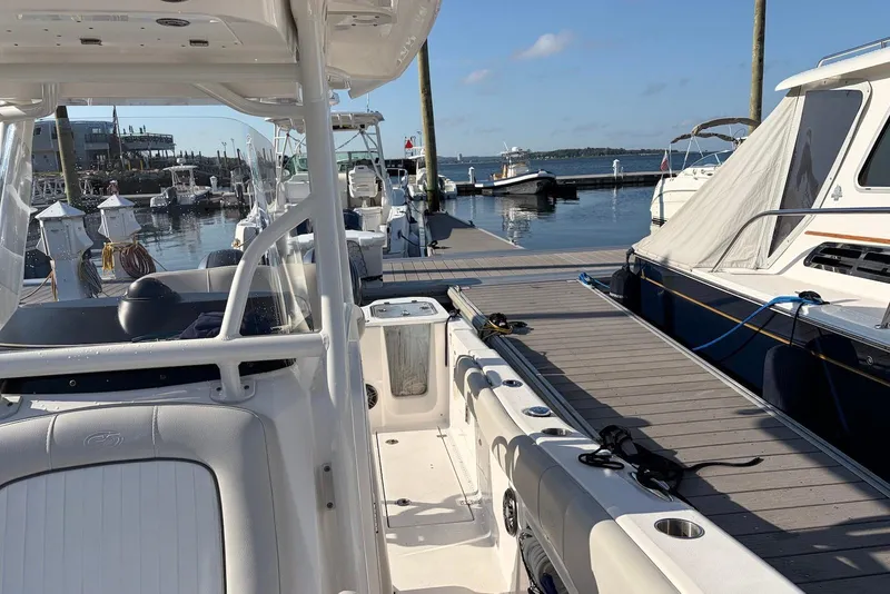Slide: The Image of 2022 Sea Fox 268 Commander docked at a marina, showcasing sleek design and spacious layout. - 7
