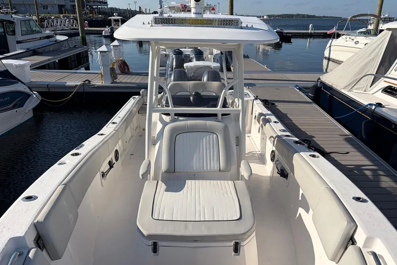 Slide: The Image of 2022 Sea Fox 268 Commander boat docked at marina, showcasing spacious seating and sleek design. - 11