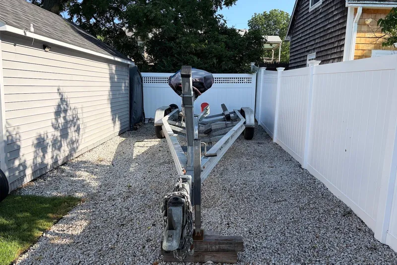 Slide: The Image of Boat trailer parked on gravel beside a house, ready for Sea Fox 268 Commander. - 20