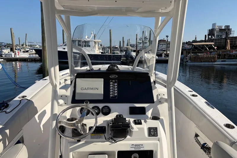 Slide: The Image of 2022 Sea Fox 268 Commander boat dashboard with Garmin navigation, docked at marina. - 14