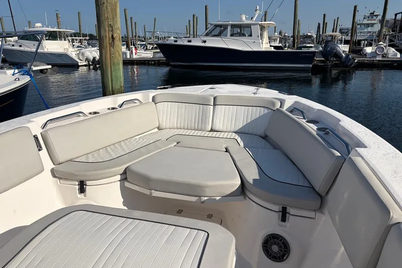 Slide: The Image of 2022 Sea Fox 268 Commander boat with spacious seating in a marina setting. - 12