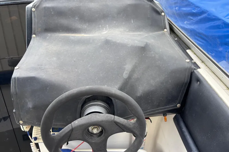 Slide: The Image of Steering wheel of a 1992 Bayliner 2850 Contessa boat, covered dashboard. - 6