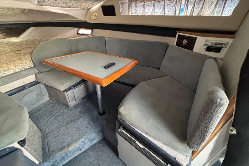 Slide: The Image of Interior of 1992 Bayliner 2850 Contessa with cozy seating and table. - 8