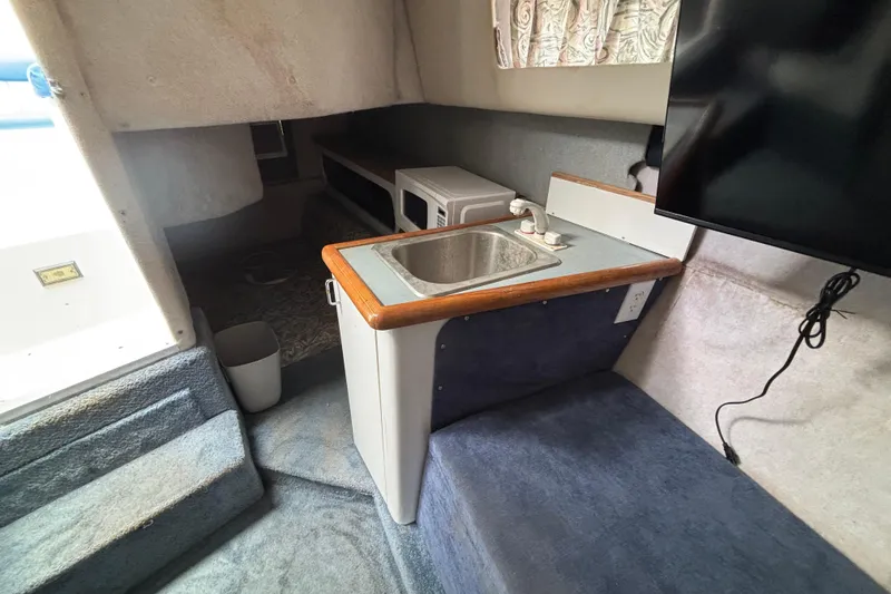 Slide: The Image of Interior of 1992 Bayliner 2850 Contessa with sink, microwave, and TV. - 10