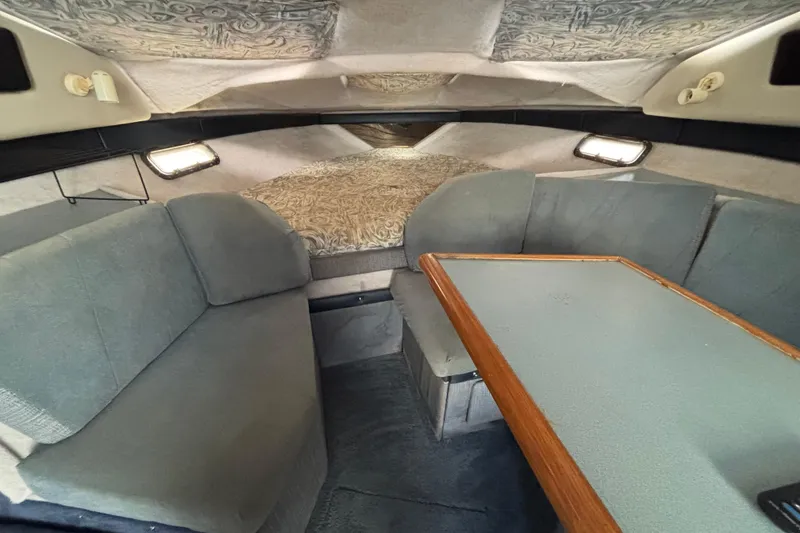 Slide: The Image of Interior of 1992 Bayliner 2850 Contessa boat with seating and table. - 9