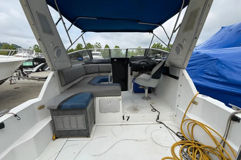 Slide: The Image of 1992 Bayliner 2850 Contessa boat interior with seating, helm, and canopy. - 4