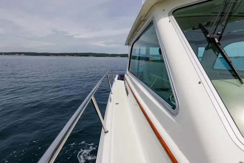 Slide: The Image of 2017 Back Cove Yachts 37 cruising on calm waters, showcasing sleek design and ocean view. - 23