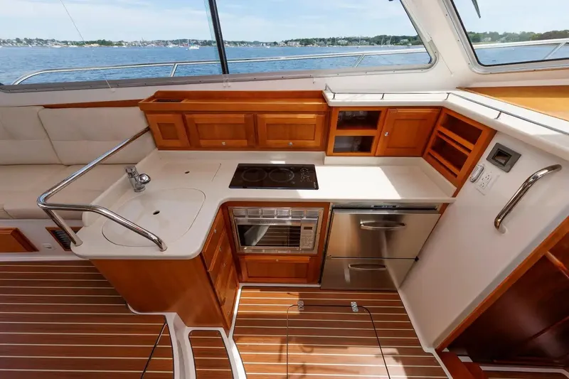 Slide: The Image of Luxurious 2017 Back Cove Yachts 37 interior kitchen with wooden cabinetry and modern appliances. - 42