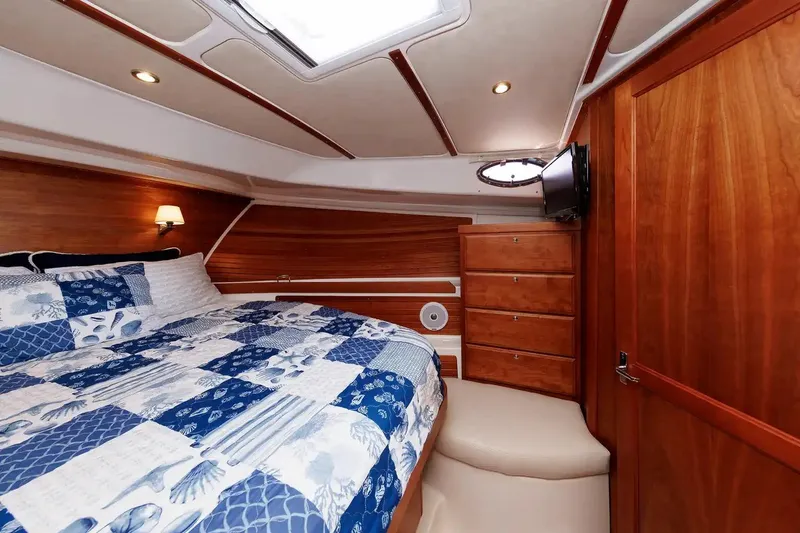 Slide: The Image of Luxurious cabin interior of 2017 Back Cove Yachts 37 with wood finish and cozy bedding. - 47