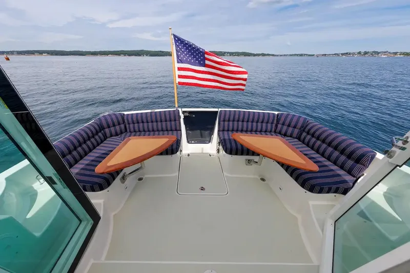 Slide: The Image of 2017 Back Cove Yachts 37 with American flag, featuring spacious seating and ocean view. - 25