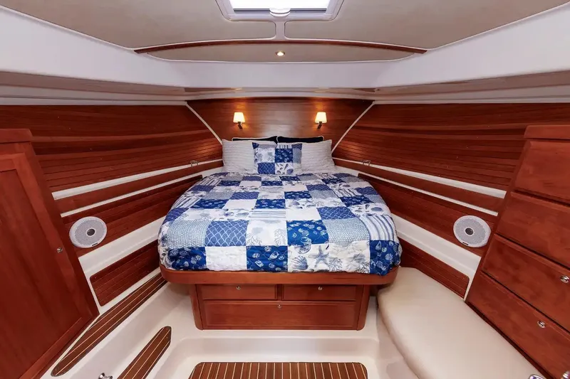Slide: The Image of Luxurious cabin interior of 2017 Back Cove Yachts 37 with cozy bed and wood paneling. - 46