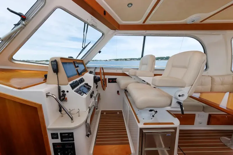 Slide: The Image of Interior of 2017 Back Cove Yachts 37, featuring helm station and plush seating. - 34